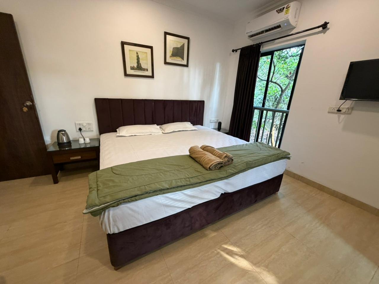 Spacious bedroom with double bed and balcony view